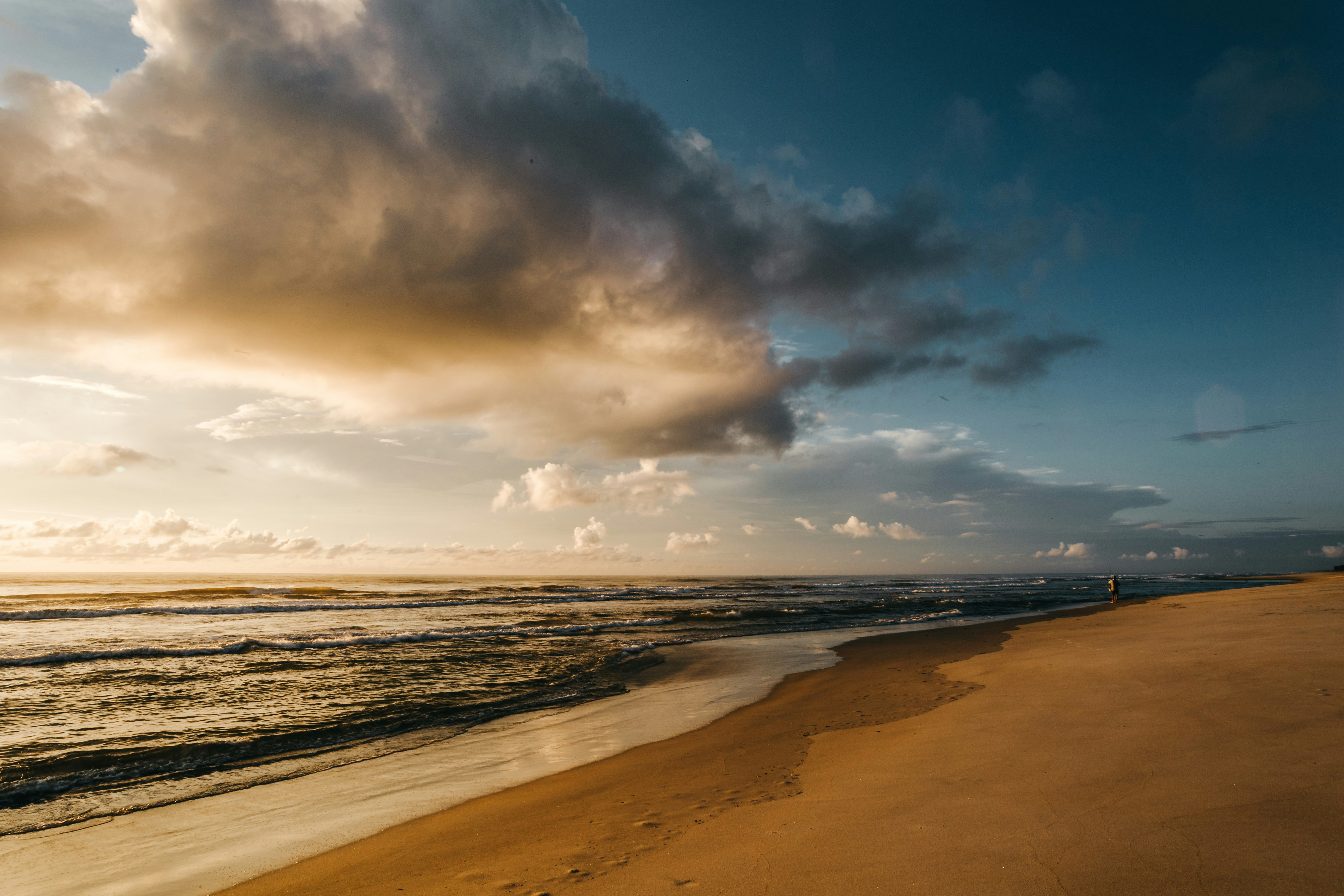 sea waves crashing on shore during sunset